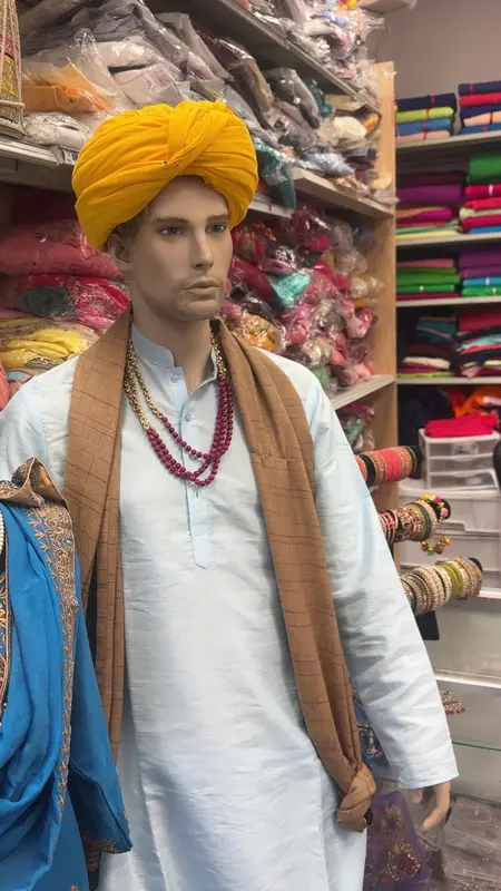 Men's kurta with a marigold turban on a mannequin
